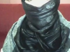 Bored arab girl in hijab plays on her calculator